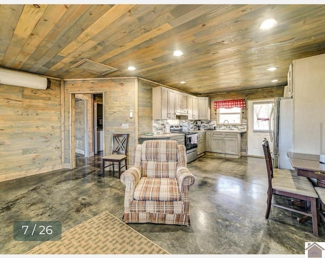 living room with an AC wall unit, wood ceiling, wooden walls, and sink