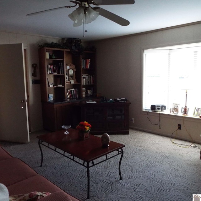 carpeted living room with ceiling fan