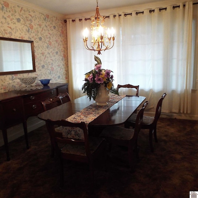 dining area with crown molding and a chandelier