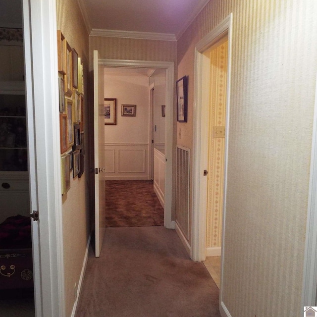 corridor with carpet and crown molding