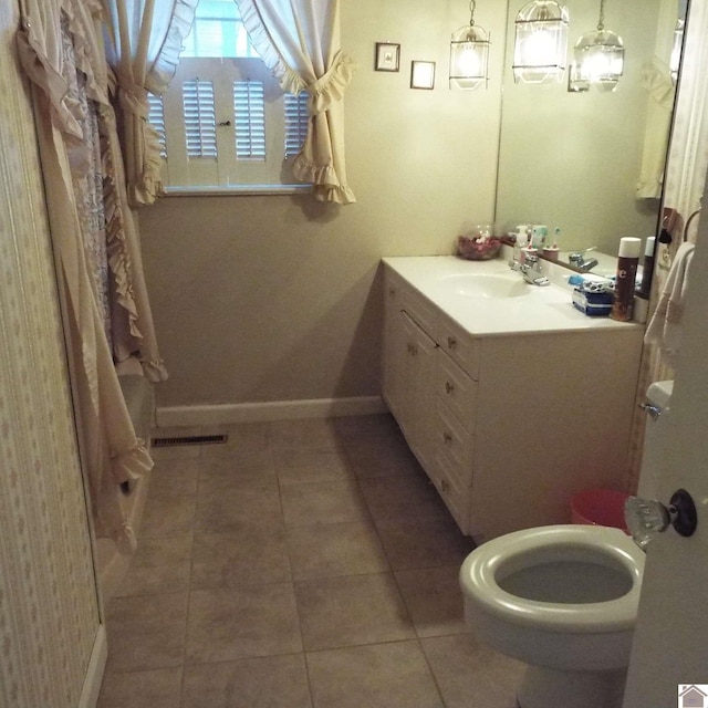 bathroom featuring tile patterned floors, vanity, and toilet