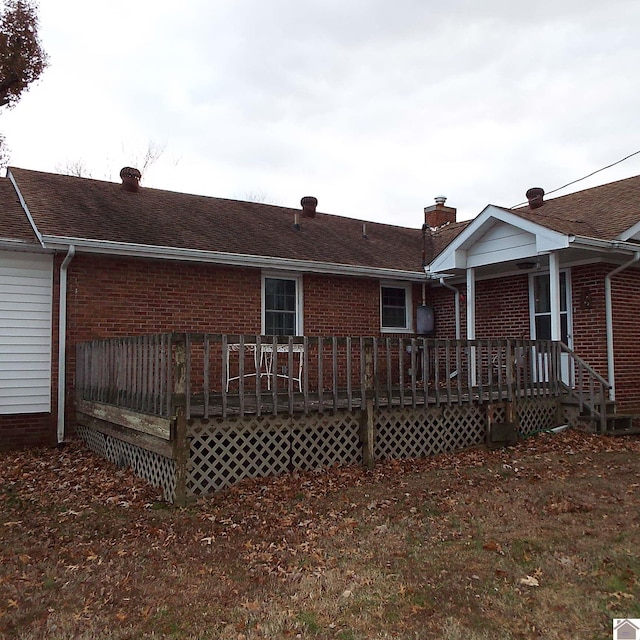 back of house with a wooden deck