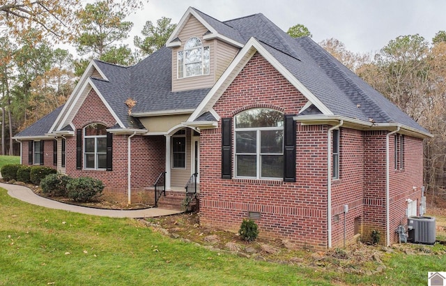 front facade with central AC unit and a front lawn