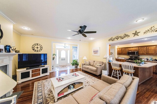 living room with ornamental molding, a textured ceiling, ceiling fan, and dark wood-type flooring