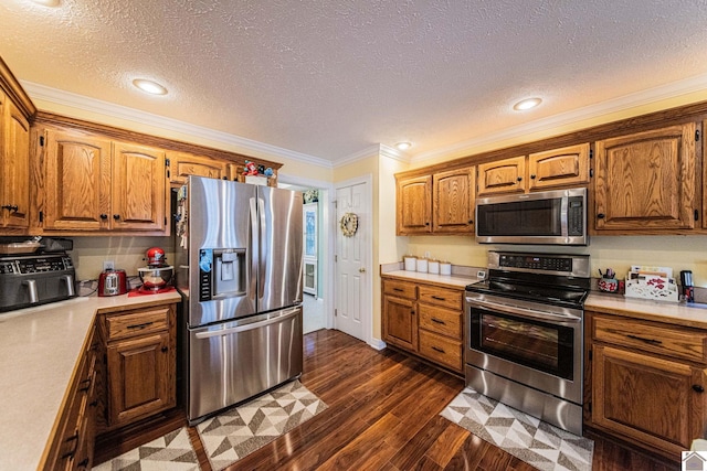 kitchen featuring a textured ceiling, dark hardwood / wood-style floors, crown molding, and appliances with stainless steel finishes