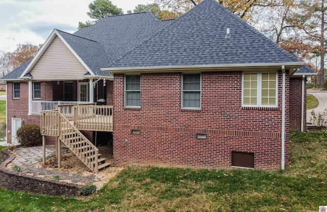 rear view of house featuring a wooden deck