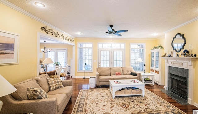 living room featuring a fireplace, a textured ceiling, dark hardwood / wood-style floors, and crown molding