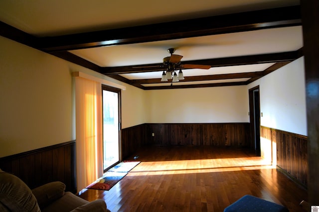 unfurnished room featuring ceiling fan, beamed ceiling, and light hardwood / wood-style floors