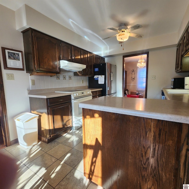 kitchen with decorative backsplash, kitchen peninsula, dark brown cabinets, white range with electric stovetop, and stainless steel fridge with ice dispenser