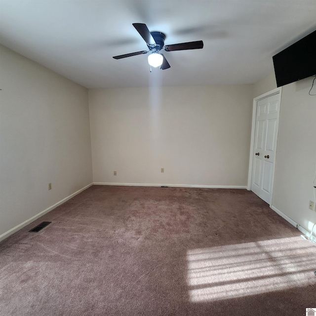 empty room with carpet flooring and ceiling fan