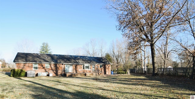 rear view of house with a lawn