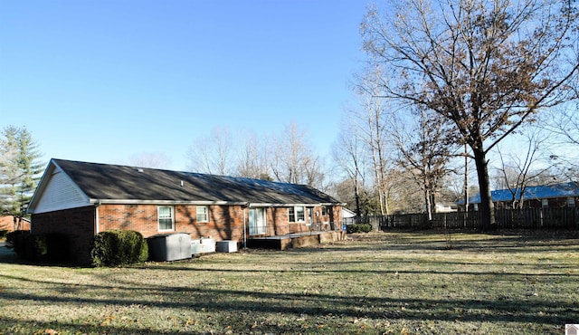 back of house with a lawn