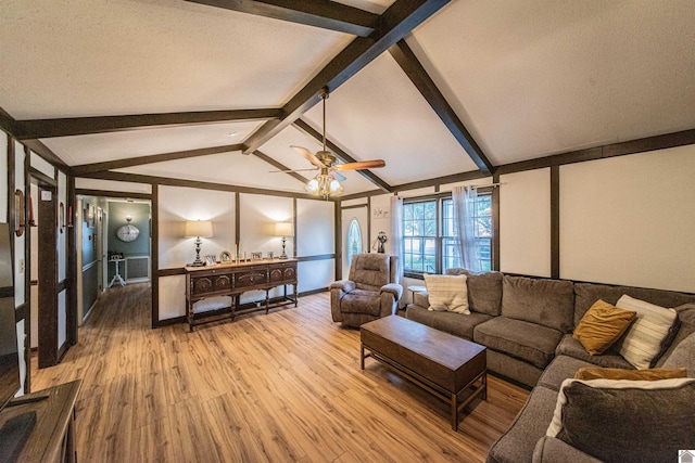 living room with a textured ceiling, lofted ceiling with beams, light hardwood / wood-style floors, and ceiling fan