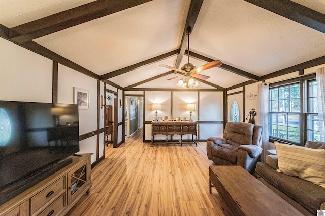 living room with lofted ceiling with beams, ceiling fan, light hardwood / wood-style floors, and a textured ceiling