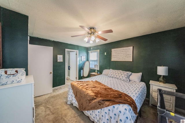 carpeted bedroom featuring ceiling fan and a textured ceiling