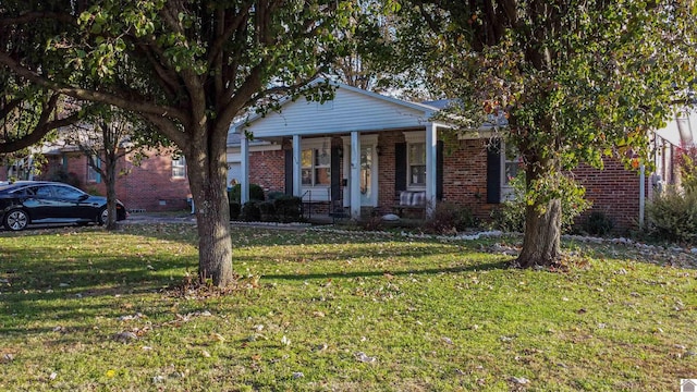 view of front of home with a porch and a front yard