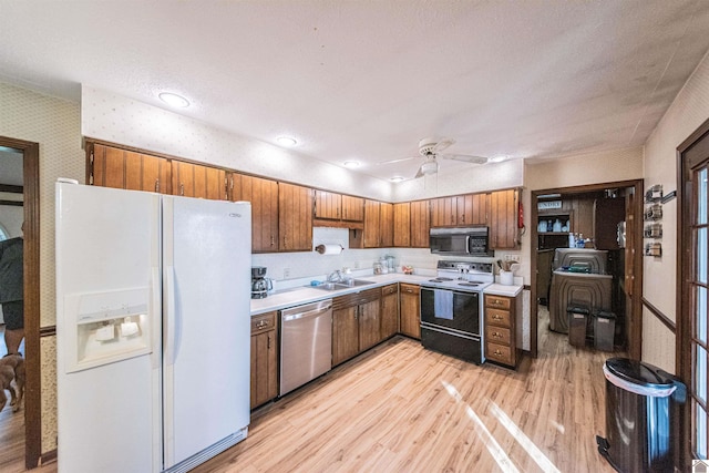 kitchen featuring white refrigerator with ice dispenser, light wood-type flooring, range with electric stovetop, and dishwasher