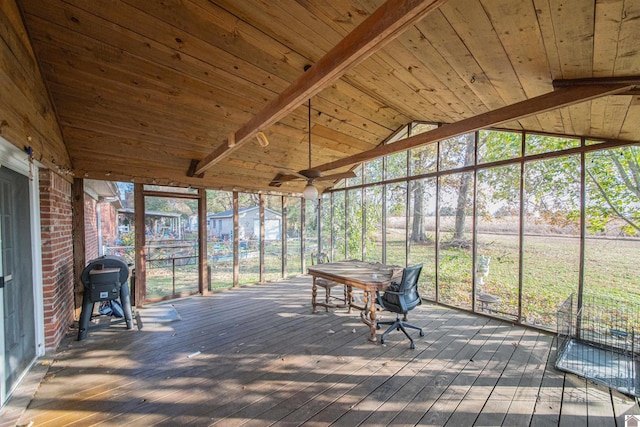 unfurnished sunroom featuring vaulted ceiling with beams, ceiling fan, and wooden ceiling