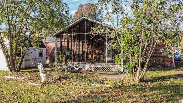 rear view of house featuring a sunroom