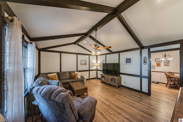 living room featuring hardwood / wood-style flooring, lofted ceiling with beams, ceiling fan, and a textured ceiling