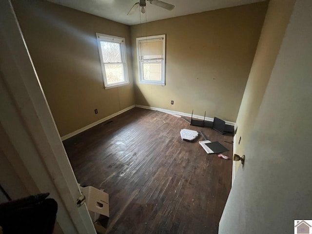 unfurnished room with dark hardwood / wood-style floors and ceiling fan