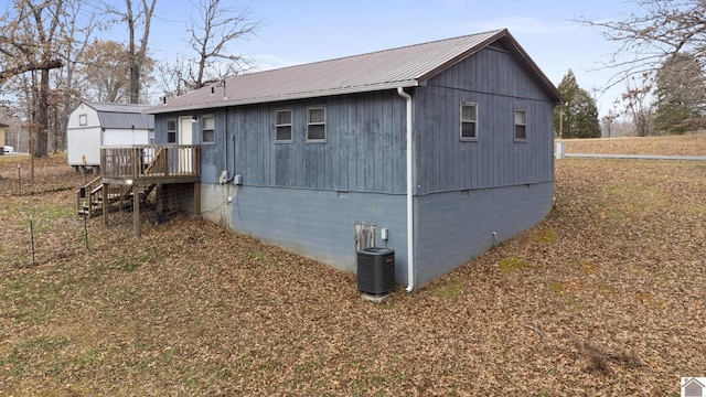 view of property exterior featuring central AC unit and a deck