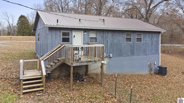 rear view of property with central AC