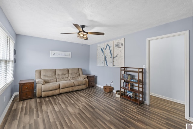 living room featuring a textured ceiling, dark hardwood / wood-style floors, and ceiling fan