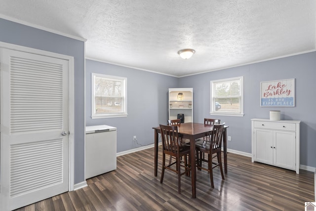 dining space featuring ornamental molding, a textured ceiling, and dark wood-type flooring