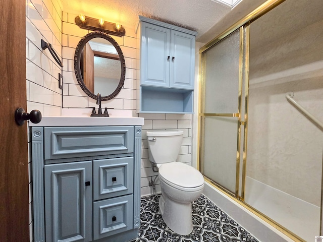 bathroom featuring toilet, a stall shower, and tile walls