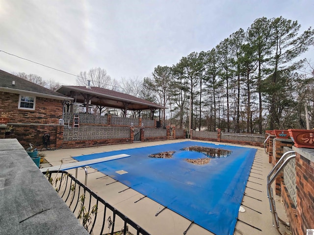 view of swimming pool featuring fence