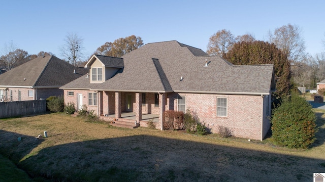 back of property featuring a lawn