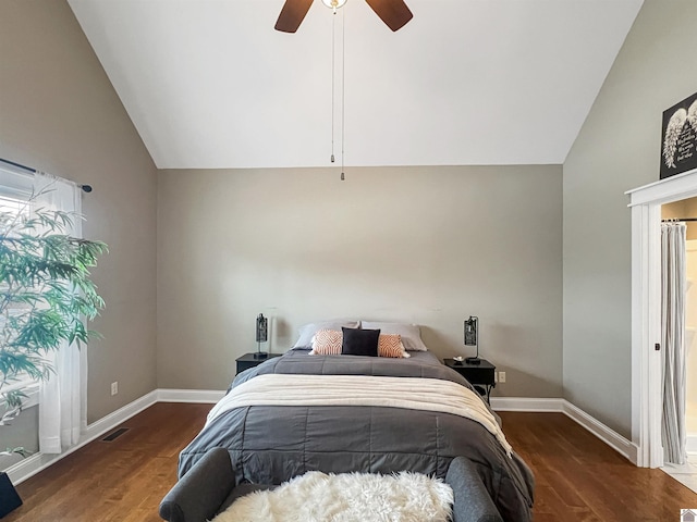 bedroom featuring dark hardwood / wood-style floors, vaulted ceiling, and ceiling fan