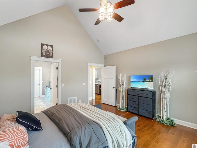 bedroom with hardwood / wood-style floors, ceiling fan, and high vaulted ceiling