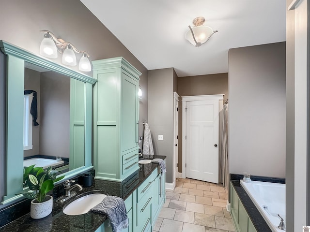 bathroom with a bath, vanity, and tile patterned floors