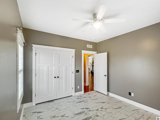 unfurnished bedroom featuring a closet and ceiling fan