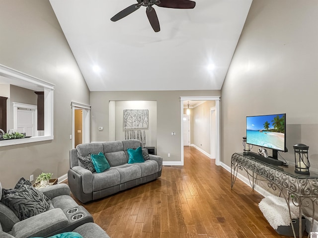 living room with hardwood / wood-style floors, high vaulted ceiling, and ceiling fan