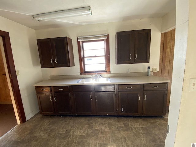 kitchen with dark brown cabinetry and sink