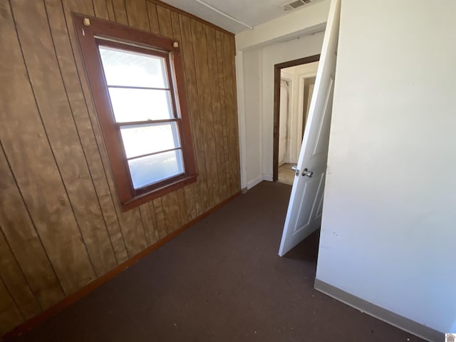 hallway with wood walls