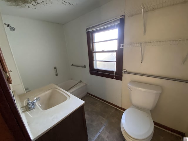 bathroom featuring vanity, a bathtub, and toilet