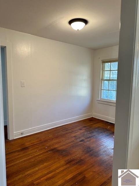 unfurnished room featuring dark hardwood / wood-style floors