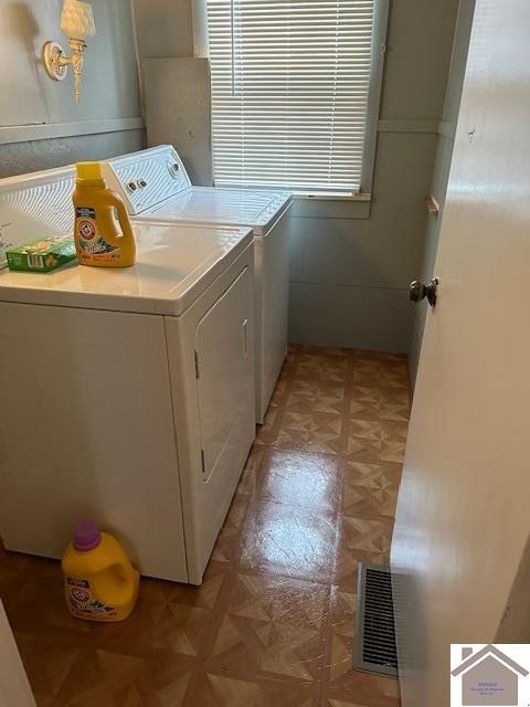 washroom featuring light parquet flooring and separate washer and dryer