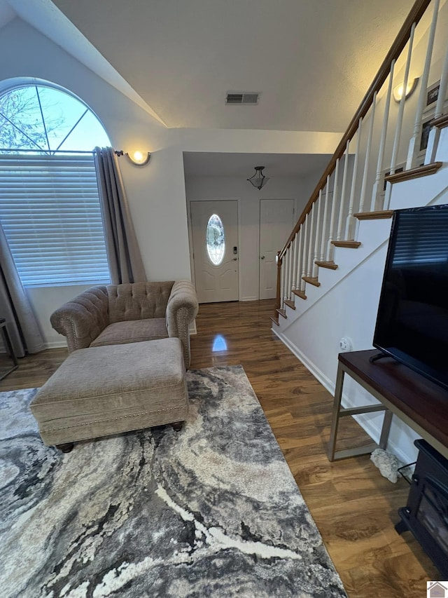 entryway featuring vaulted ceiling and dark hardwood / wood-style floors