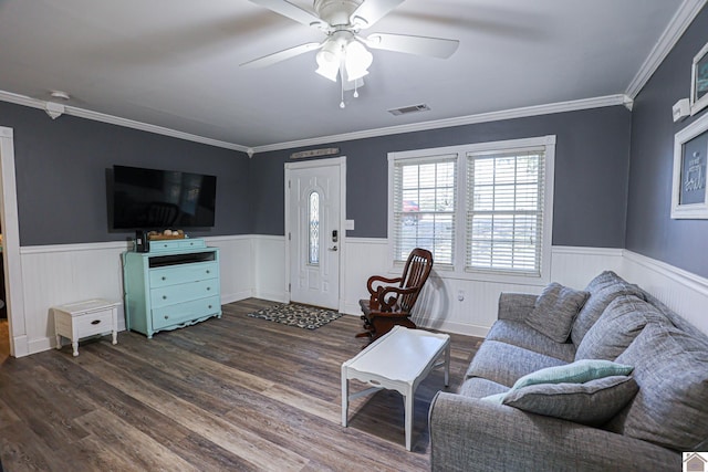 living room featuring dark hardwood / wood-style flooring, ceiling fan, and ornamental molding