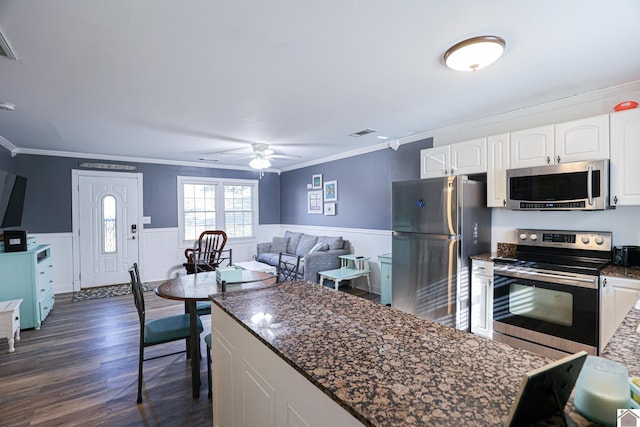 kitchen featuring white cabinetry, ornamental molding, dark hardwood / wood-style floors, and appliances with stainless steel finishes