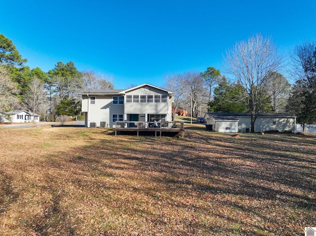 back of house featuring a deck and a yard