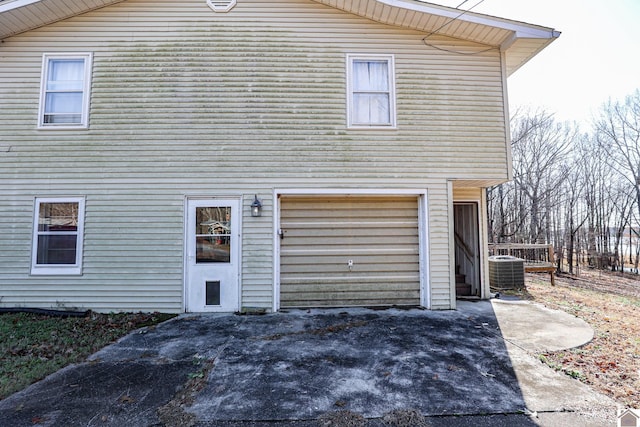 view of home's exterior featuring a garage and central air condition unit