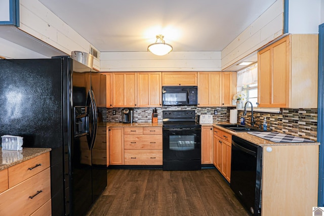 kitchen with light stone countertops, sink, tasteful backsplash, dark hardwood / wood-style floors, and black appliances