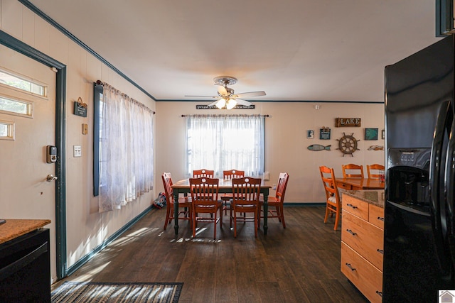 dining area featuring ceiling fan, a healthy amount of sunlight, crown molding, and dark wood-type flooring