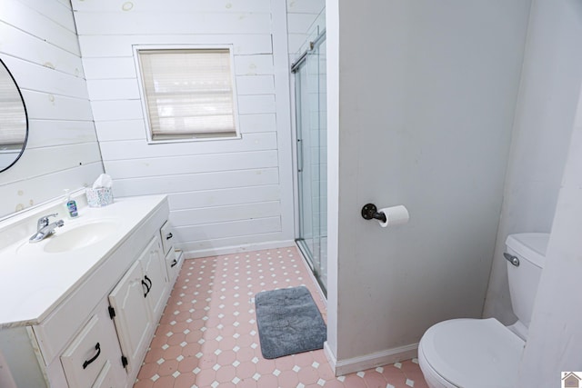 bathroom with wood walls, toilet, vanity, and walk in shower